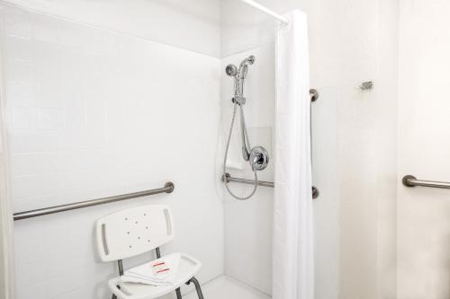 a bathroom with a shower and a toilet at Howard Johnson by Wyndham Modesto Ceres in Ceres