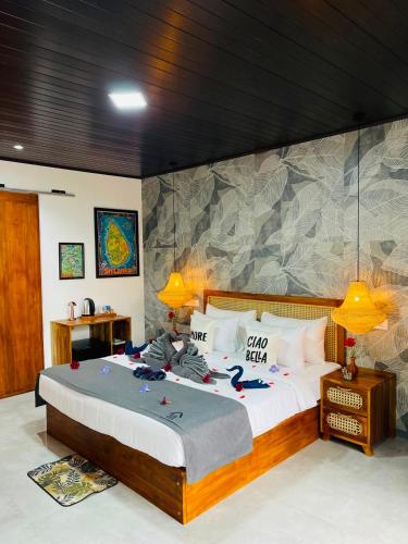 a bedroom with a large bed with clothes on it at La Casa Bella in Ella
