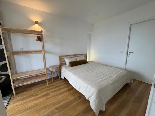 a bedroom with a bed and a ladder in it at Blue Whale Appartment in Horta