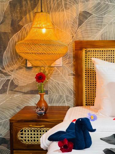 a bedroom with a stuffed animal on a bed with a lamp at La Casa Bella in Ella