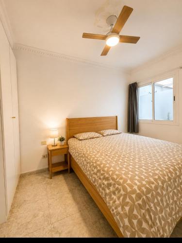a bedroom with a bed and a ceiling fan at Roca Mogán in Puerto de Mogán