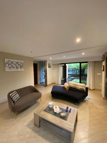 a living room with two couches and a coffee table at Sunny Suites Madagascar in Antananarivo