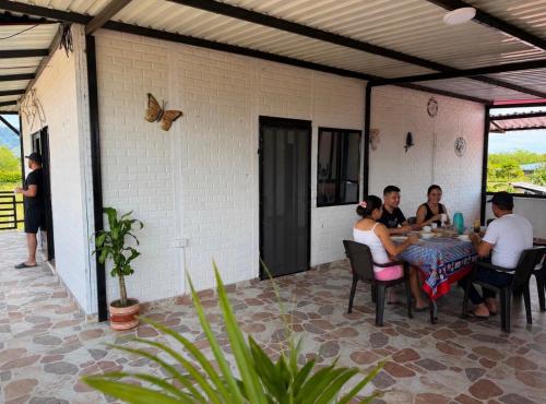 a group of people sitting around a table on a patio at Diamante 38 in La Dorada