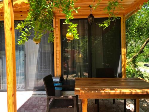 a screened in porch with a wooden table at Selale Cennet Evleri in Kemer