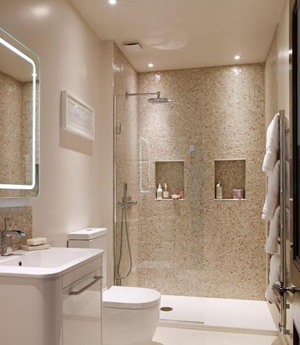 a bathroom with a shower and a toilet and a sink at Naini reflections in Nainital