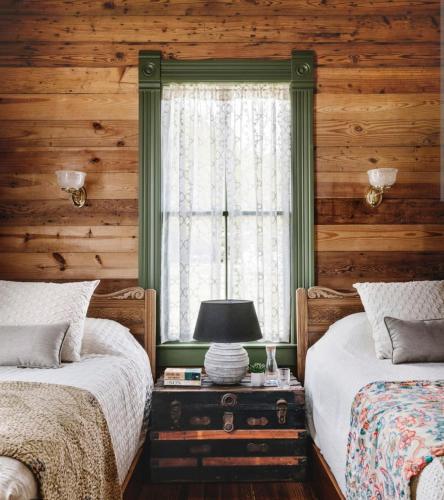 a bedroom with two beds and a window at Naini reflections in Nainital
