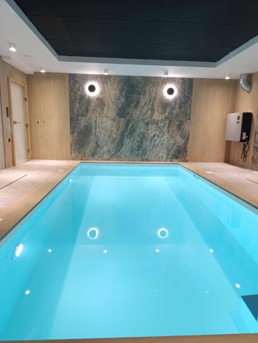a swimming pool with blue lighting in a room at Willa Górska Pasja in Szczyrk