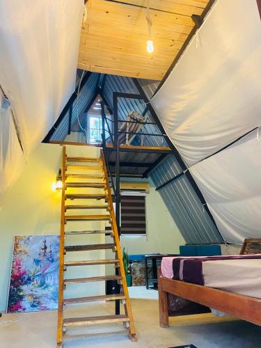 a staircase in a room with a tent at Saruketha Cabana in Kegalle