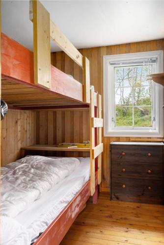 a bedroom with two bunk beds and a window at Åstin in Dirdal