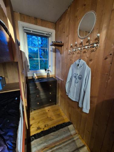a bathroom with a white shirt hanging on a wall at Åstin in Dirdal