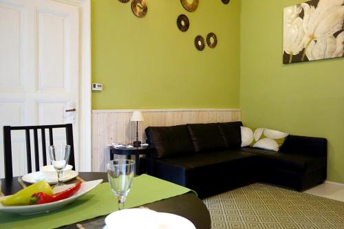 布達佩斯的住宿－熱鬧羅薩公寓，客厅配有黑色沙发和桌子
