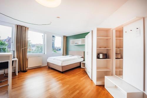 a bedroom with a bed and shelves in a room at Brera Nürnberg in Nuremberg