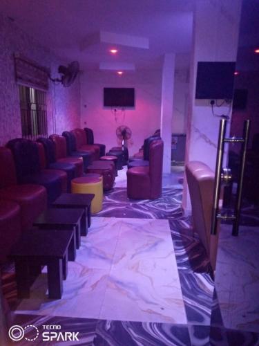 a waiting room with couches and chairs in a theater at AAJBLissful in Idowu