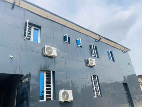 a mirrored facade of a building with windows at AAJBLissful in Idowu