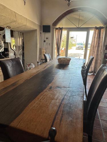 a wooden table with chairs and a large wooden table sidx sidx at Maison L'étalonblanc in Tupin-et-Semons