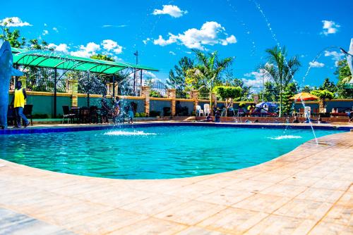 a pool at a resort with a fountain at Armaflex hotel SMC LTD in Lira