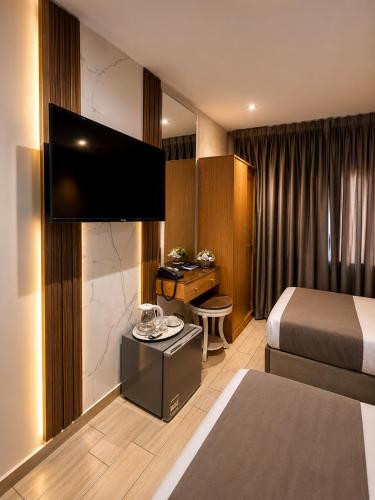 a hotel room with a bed and a flat screen tv at lotus view El tahrir in Cairo