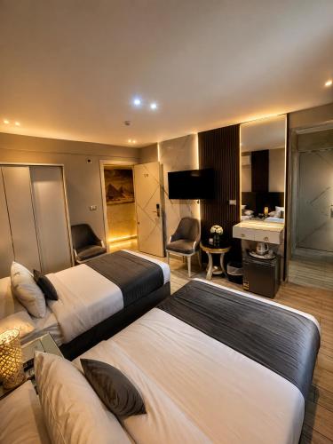 a hotel room with two beds and a desk at lotus view El tahrir in Cairo