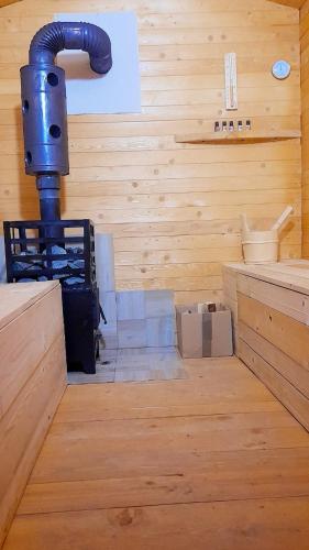 a bathroom with a pipe in a wooden room at La Ianis in Vatra Dornei