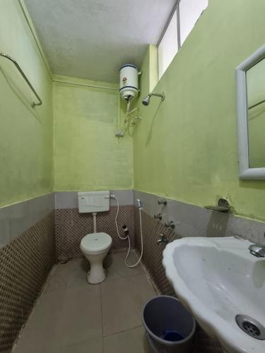 a bathroom with a toilet and a sink at North Queen Homestay in Darjeeling