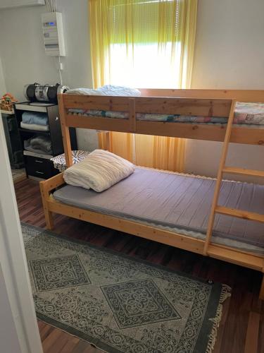 a bedroom with two bunk beds and a rug at Vacker hus i naturen in Fröseke