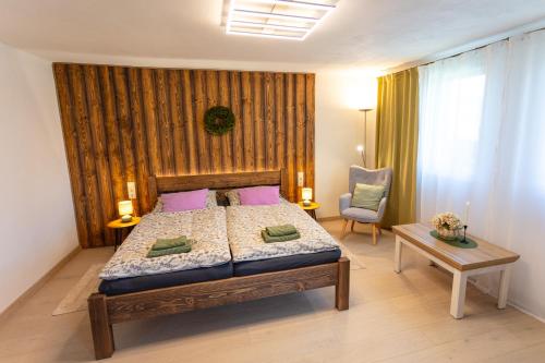 a bedroom with a bed and a table and a chair at Drevenička Levanduľa in Liptovská Kokava
