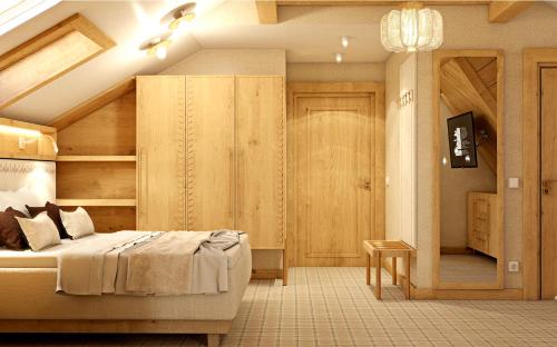 a bedroom with a large bed and a room with a door at Ku Dolinie in Kościelisko