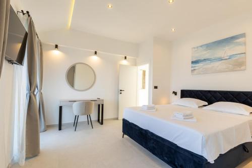 a bedroom with a bed and a desk and a mirror at Stone house Mia in Čara