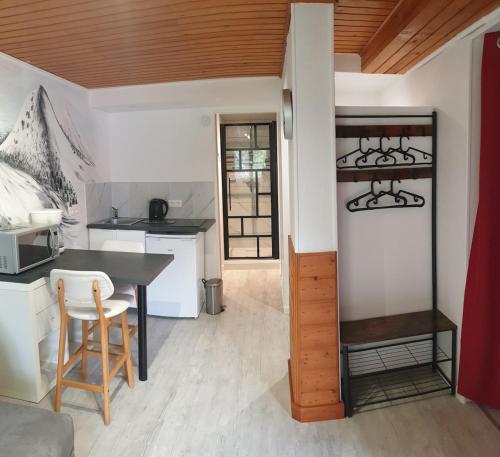 a kitchen and dining room with a table and chairs at Studio dans mon chalet La Mère Veille in La Girard