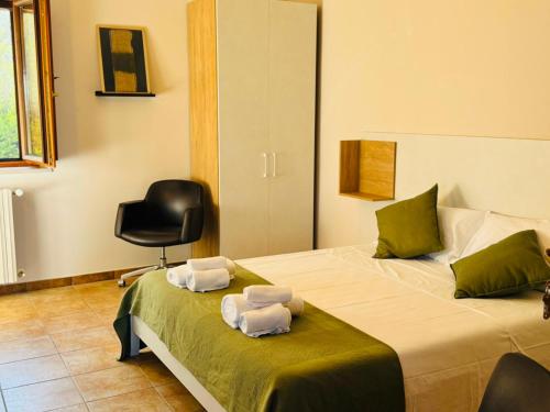 a bedroom with two beds with folded towels on them at Numa Living in Rapone