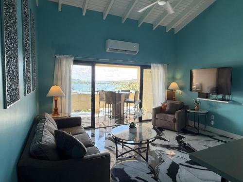 a living room with a couch and a table at Spacious 2BR Retreat • Balcony Views + Parking in Nazareth