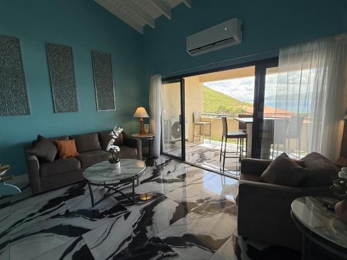 a living room with a couch and a table at Spacious 2BR Retreat • Balcony Views + Parking in Nazareth