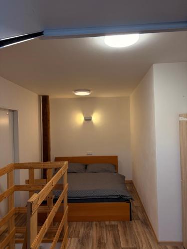 a bedroom with a bed and a staircase in it at Apartmán 2 in Zlín