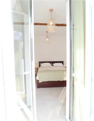 a bedroom with a bed through a glass door at Hundred Noons in Khandrinós