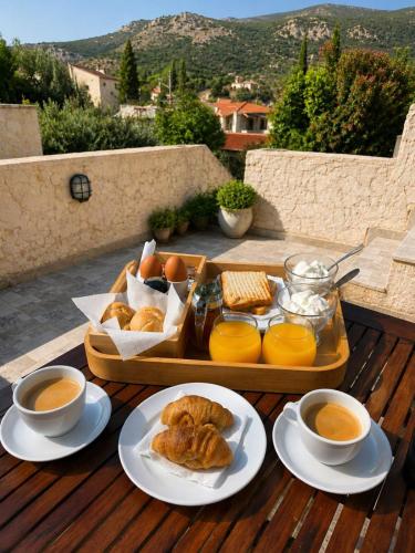a tray of pastries and cups of coffee on a table at Castello in Porto Kagio