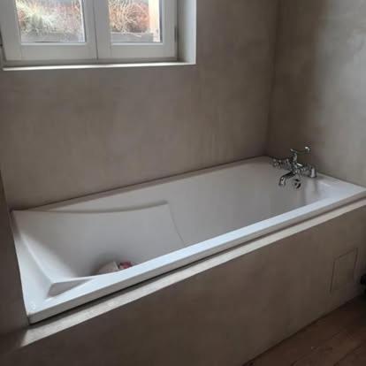 a white bath tub in a bathroom with a window at La Villa Regula in La Réole