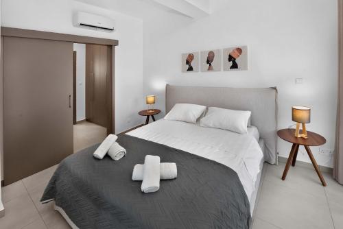 a bedroom with a bed with two towels on it at Sun & Moon Luxury - Eclipse Villa in Ayia Napa