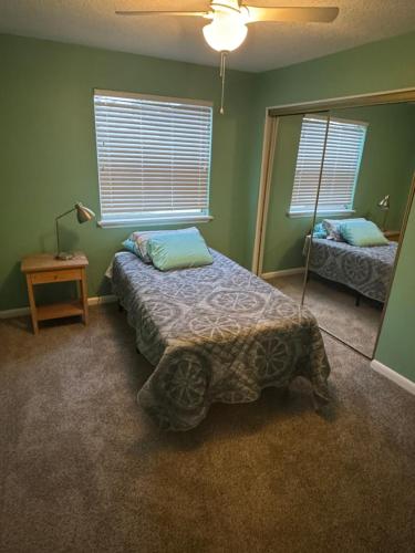a bedroom with a bed and a mirror at Spacious cozy in Jacksonville