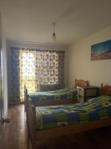 a bedroom with two beds and a window at Marsel Odesa in Odesa
