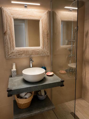 a bathroom with a sink and a shower at Lichno Spirit in Vourliótai