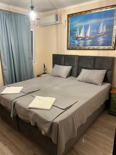 a bedroom with a large bed with two towels on it at Guest House Budva in Budva