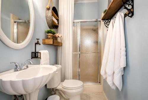 a bathroom with a sink and a toilet and a shower at King bed! Gameroom! Super cozy-The Treasured Mist! in Fort Smith