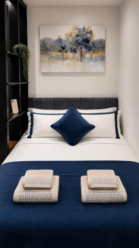 a bedroom with a bed with two pillows on it at The Studio Spot in Caerphilly