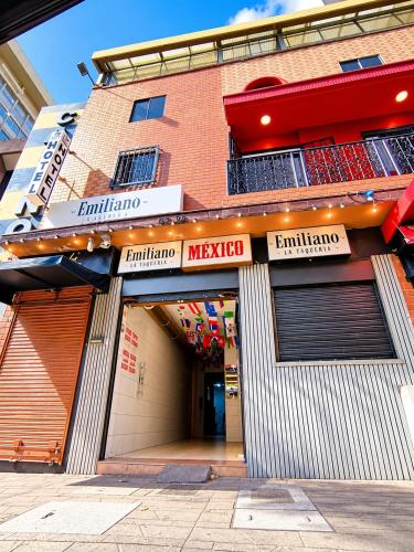 a store front of a brick building with signs on it at Hotel Nexo in Medellín