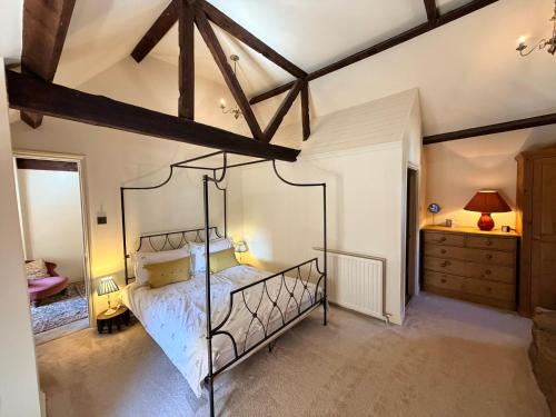 a bedroom with a metal bed in a room at Braunston Manor Cottage in Braunston