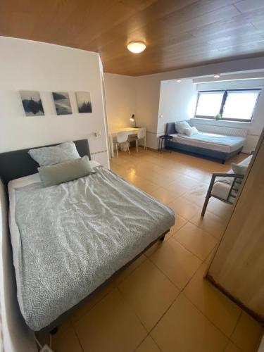 a bedroom with a bed and a table and a couch at Western in Mörfelden-Walldorf