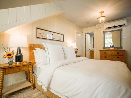 a bedroom with a large bed with white sheets and pillows at Sawyer House in Nantucket