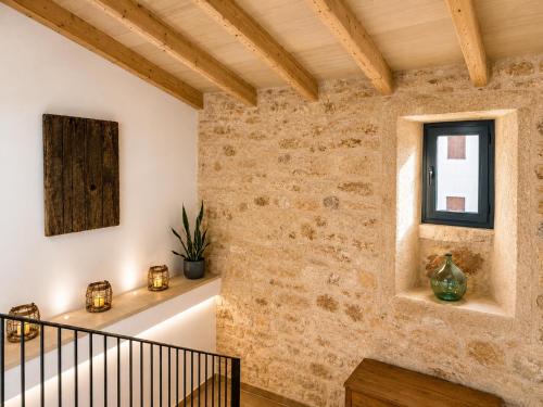 a staircase in a house with a stone wall at Can Roig in Ses Salines