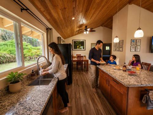 a family in the kitchen of a tiny house at Family Friendly Oasis- Firepit-Puzzles-Breakfast in Mountain View