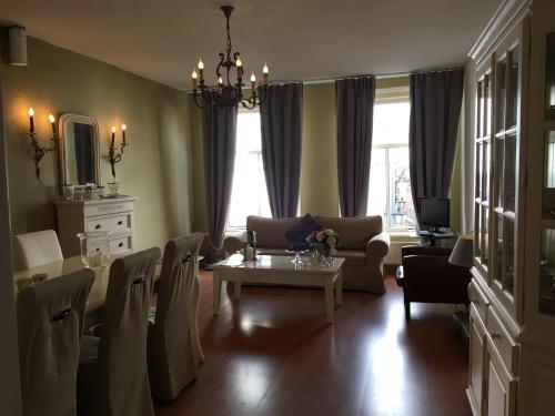 a living room with a table and a couch at La Perle Apartment in Utrecht